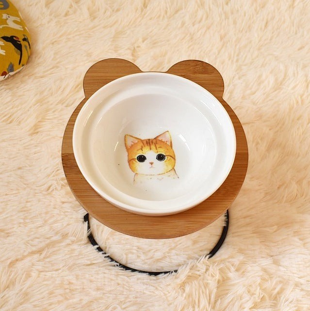 Furlouve Ergonomic Cat Dining Stand with a ceramic bowl featuring a cute tabby cat design, made of bamboo.