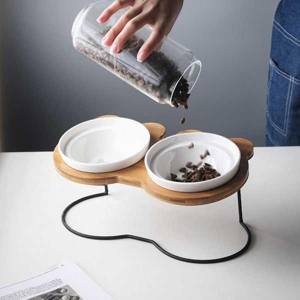 Furlouve Ergonomic Cat Dining Stand with two white ceramic bowls on a wooden base shaped like a Mickey Mouse head.