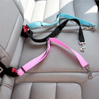 Furlouve adjustable pet car seat belt in pink, black, and sky blue nylon with metal clips, clipped into a car seat.