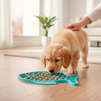 Furlouve teal silicone fish-shaped slow feeder mat with dog food for a golden retriever puppy.